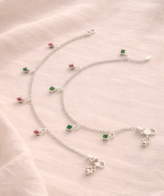 Green pink stone silver anklet worn on women feet