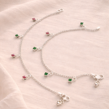 Green pink stone silver anklet worn on women feet